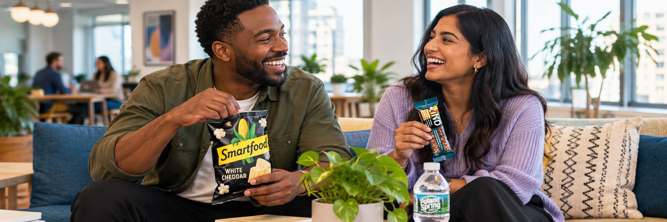 Coworkers enjoying Smartfood popcorn and a KIND bar